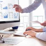 Businessmen using a finance management software for reporting.