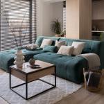 A two-piece blue-green corner sofa set placed in a modern living room.
