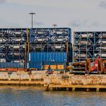 Port Miami with imported cars stacked in metal containers.