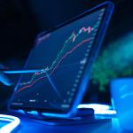 Stock market or trading graphs shown in a tablet.
