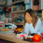 Unhappy salesperson looking exhausted behind the counter