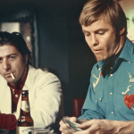 Jon Voight and Dustin Hoffman bat bar in scene from the 1969 film 'Midnight Cowboy'.