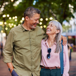 Cheerful couple walking on pedestrian street.