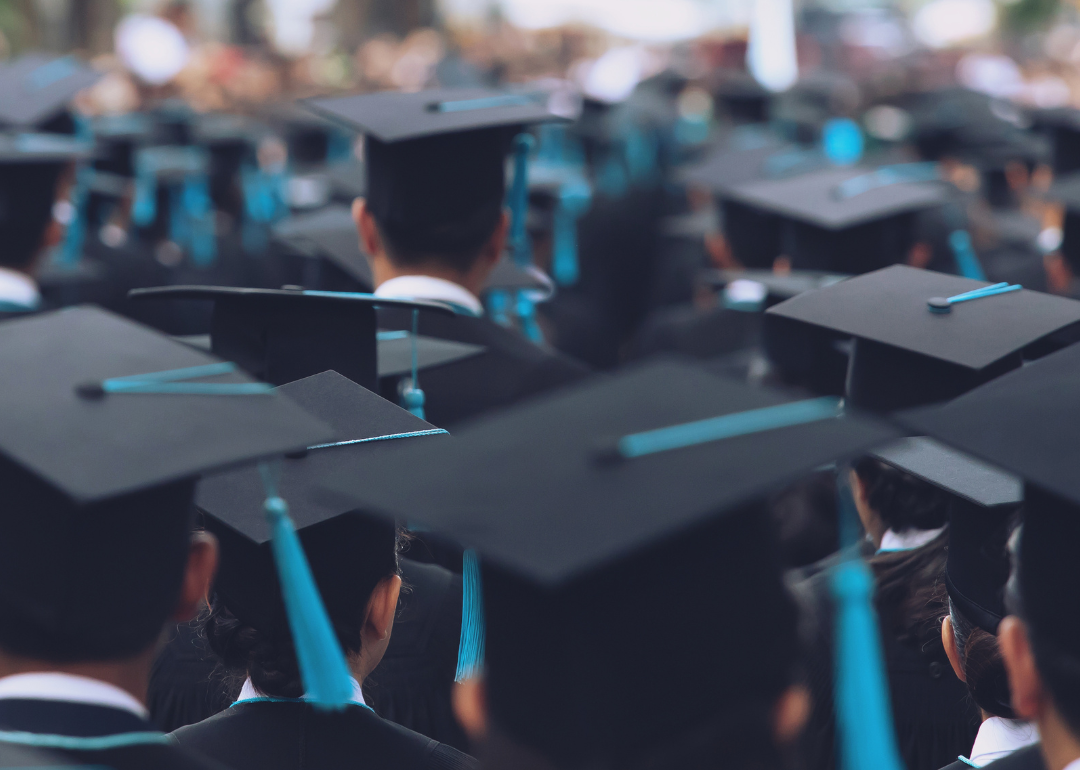 A group of college graduates dressed in caps and gowns as they wait for their graduation ceremony.