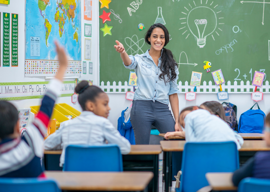 A teacher calling on a student in a classroom.