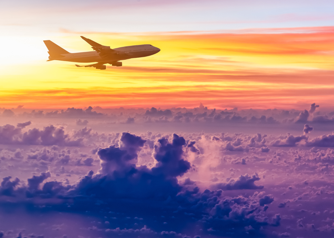 An airplane in the sky at sunrise