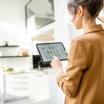 A woman controlling her smart home on a tablet