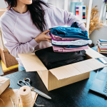 A woman fills a package for her small, ecommerce business