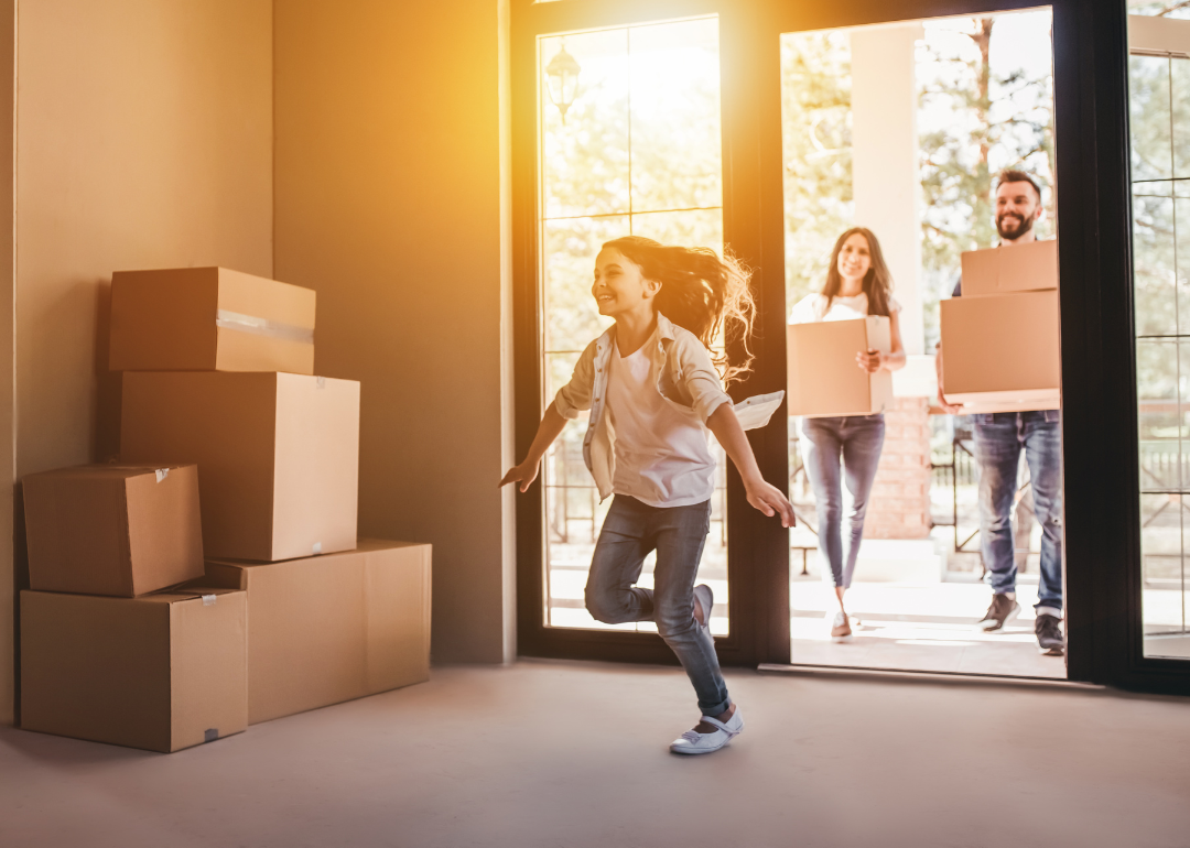 A family moving boxes into a new home.