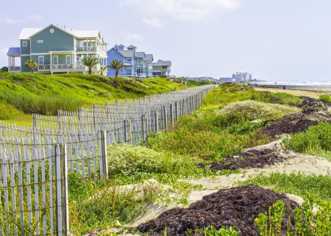 Large pastel homes on the beach.