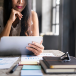 Woman looking at tablet and research.