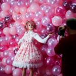 Instagram influencer "Anmaykaa" is being photographed at the "Supercandy Pop-Up Museum Vol. 2" in Cologne, western Germany with a backdrop of bright pink balloons.