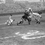 Marion Motley, Cleveland Browns Fullback is tackled.