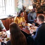 Three sets of people eating in a restaurant.