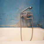 Dirty water tap in broken bathroom
