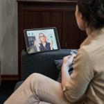 Female psychologist sitting in home office on video call with patient
