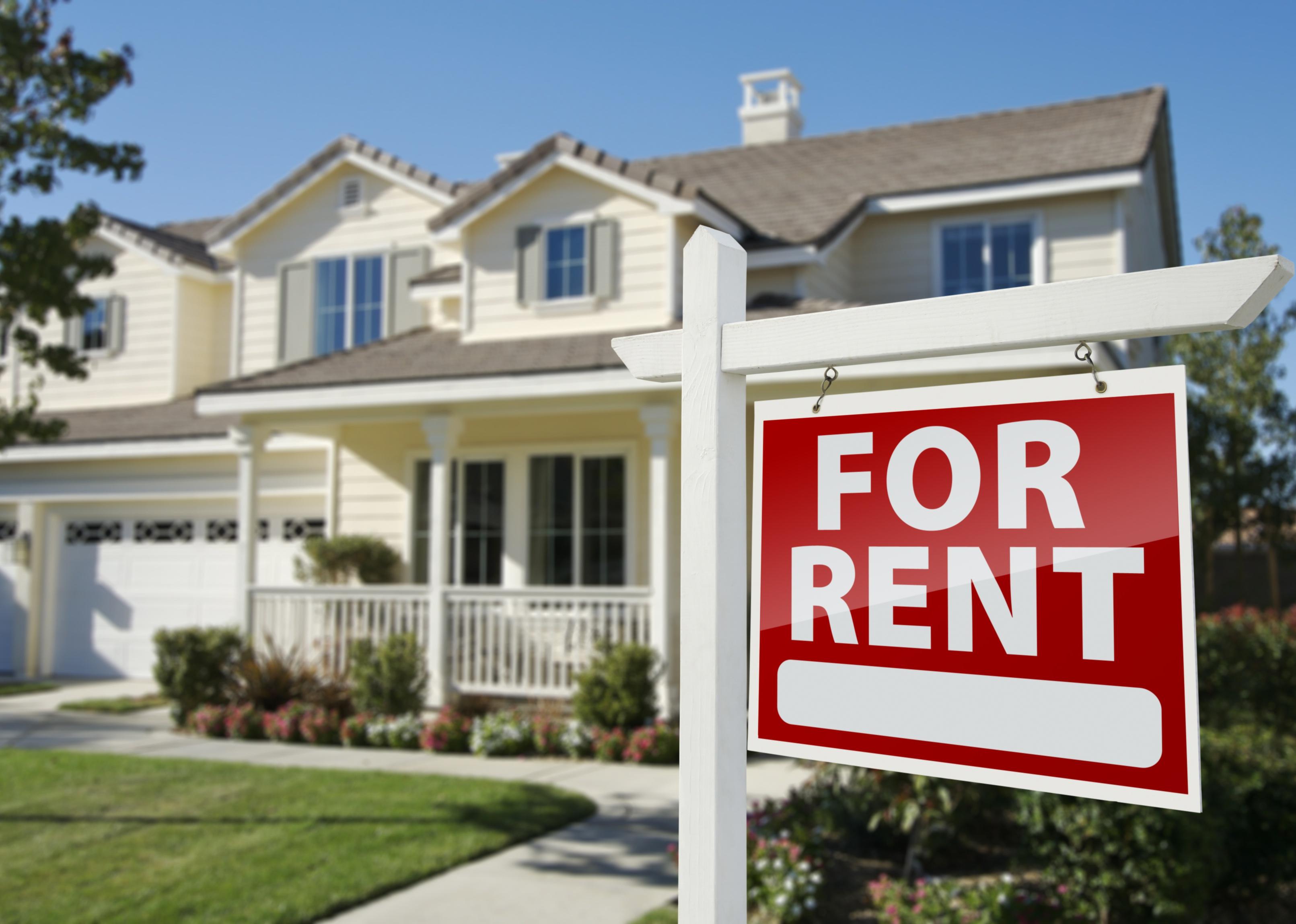 Red For Rent sign in front of a house.