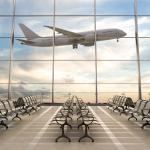 Empty airport terminal lounge with airplane on background. 