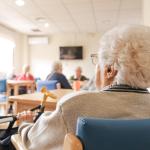 Elderly woman in a nursing home activity area.