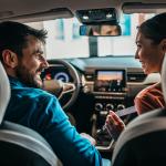 Couple inside a brand new car.