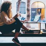 Young woman working by the window of a coworking space.