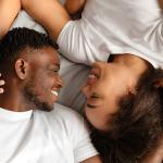 A black couple enjoying intimacy in bed.