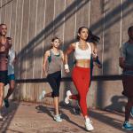 A group of people jogging outdoors.