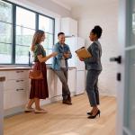 A couple talking with a real estate agent.