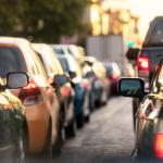 A lane of cars on the road during rush hour.