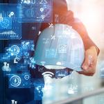 White hard hat held in the crook of a person's arm with technology icons superimposed symbolizing AI advance and sautomation of manufacturing processes using computers and electronics.