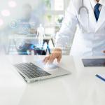 Doctor using laptop with elements of futuristic icons superimposed, symbolizing AI and technology.