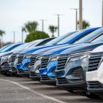 A row of Chevrolet Bolt EUV utility vehicles on a car dealership's parking lot.