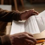 Close-up of a person reading an eviction notice letter.