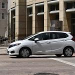 A white Honda Fit EX-L FWD car in downtown Houston, Texas.