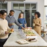 Office workers enjoying a catered lunch