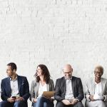 Professionals lined up sitting for a job interview.