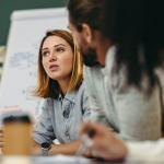 Businesswoman having a discussion with her colleagues in a meeting room.
