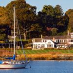 A sailboat moored off-shore near a luxury waterfront home in Greenwich, Connecticut.