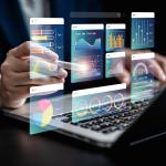 Businessman using a laptop with illustratons of finance software, charts and dashboard graphics.