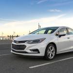 A white 2017 Chevrolet Cruz on a parking lot near seaside.