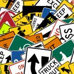 Collage of stacked road signs.