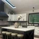 A modern kitchen with a sloped ceiling.