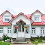 A large residential home with white and red exterior.