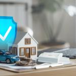 Cash, figures of a house and a car beside a laptop illustrated with a blue safety check graphic as a concept of insurance.