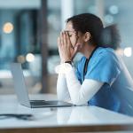 A hospital nurse experiencing burnout at work.