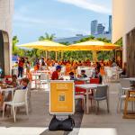 Outdoor dining areas at the Frost Museum in Florida where QR codes are seen for information and menu access.