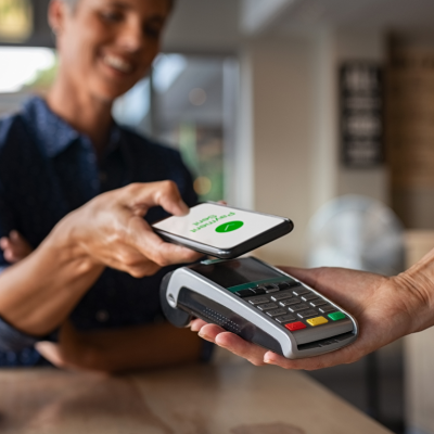 Woman paying bill with smartphone