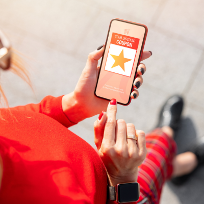 Person viewing discount coupon on phone.