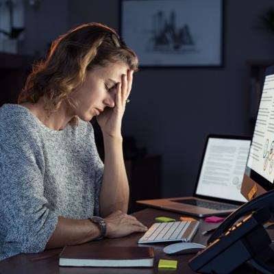 Businesswoman working on computer at night.