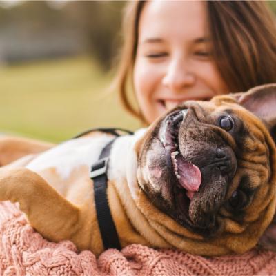 Woman holding happy dog